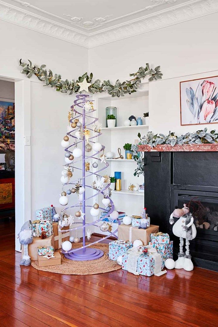 Spiral wrap Christmas lights around the tree trunk