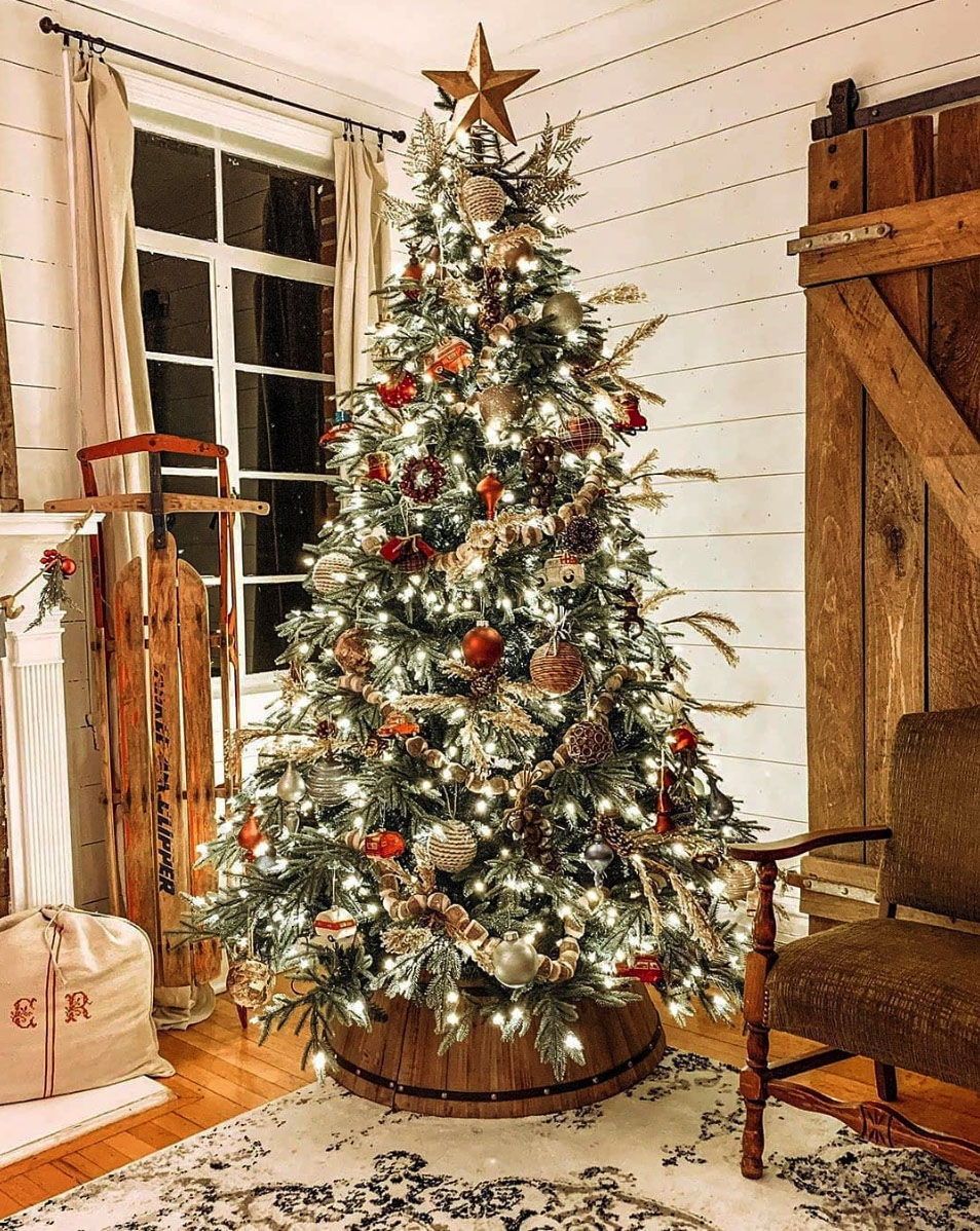 Rustic Christmas tree base with pinecones and ribbons